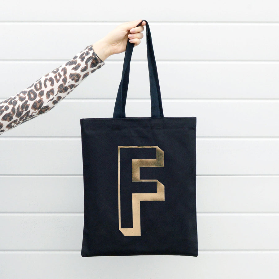 SECONDS - Initial black with gold foil Tote Bag